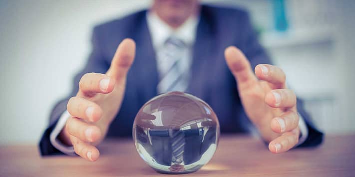 businessman making predictions from crystal ball
